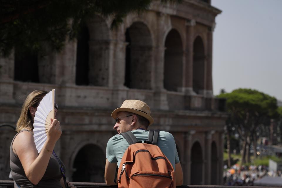 FILE - Tourists stops in front of the Colosseum in Rome, July 17, 2023. European climate monitoring organization made it official: July 2023 was Earth's hottest month on record by a wide margin. (AP Photo/Gregorio Borgia, File)