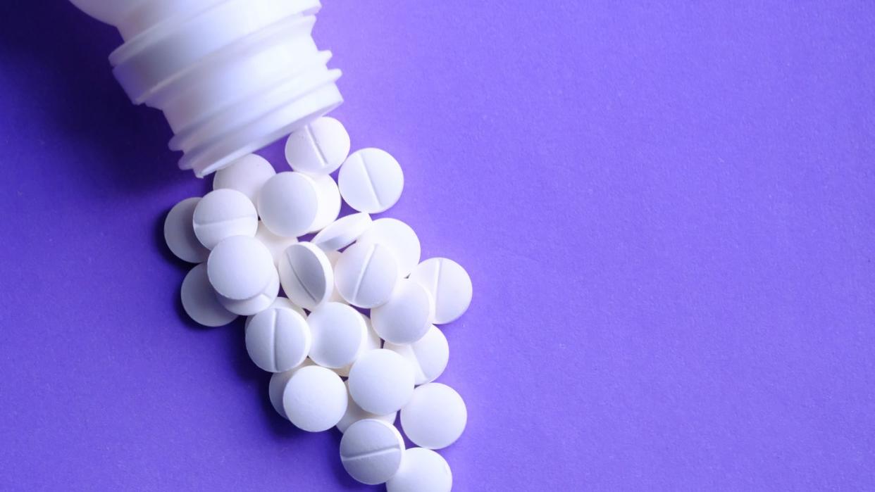 pills spills out of pill bottle, top view, medical concept