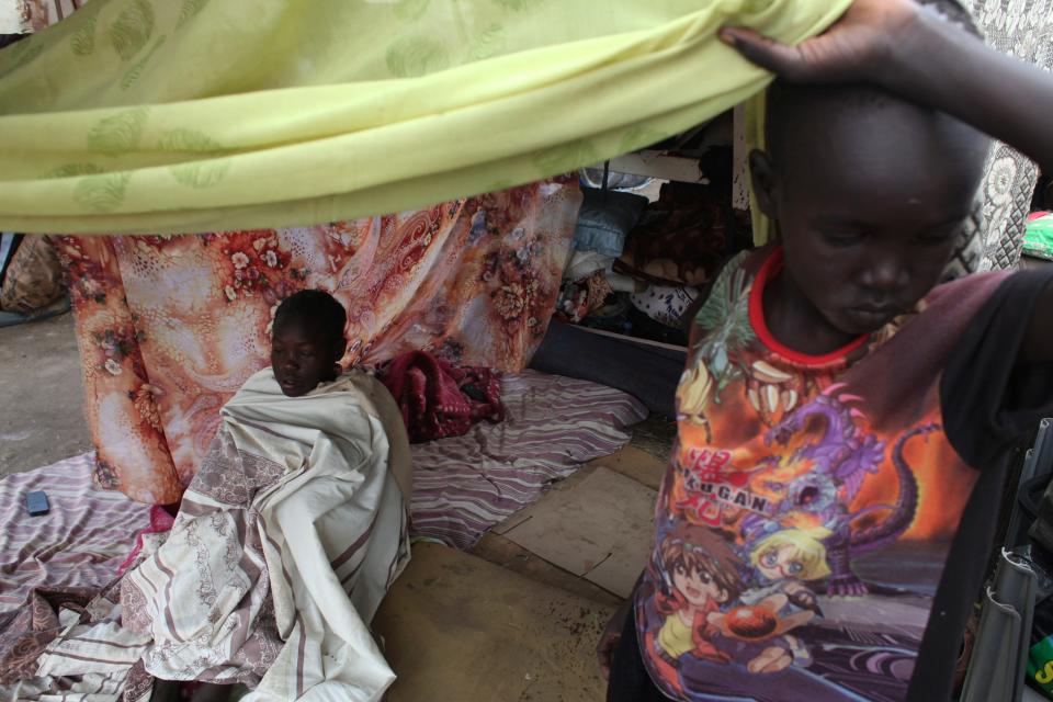 A girl with measles sits under a tent at Tomping camp in Juba, where some 17,000 displaced people who fled their homes are sheltered by the United Nations, January 10, 2014. Violence erupted in South Sudan's capital Juba in mid-December and spread to oil-producing regions and beyond, dividing the two-year-old land-locked country along ethnic lines. Some 60,000 civilians are being protected at U.N. Bases. REUTERS/Andreea Campeanu (SOUTH SUDAN - Tags: CIVIL UNREST POLITICS CONFLICT)