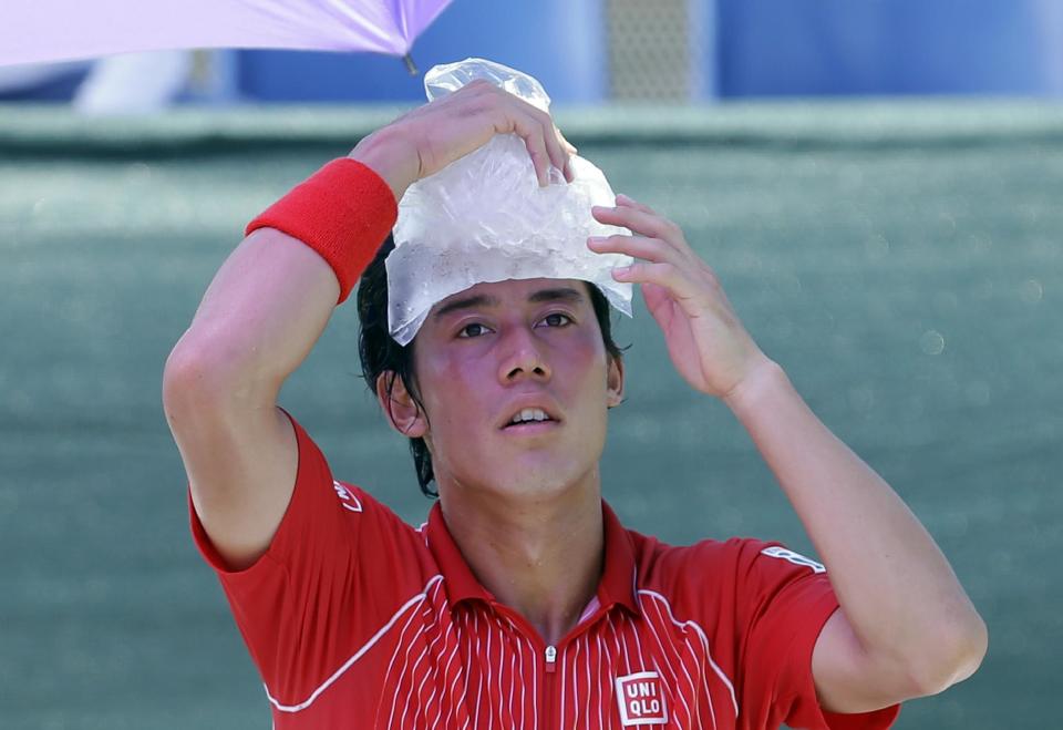 Kei Nishikori, of Japan, cools off between sets during the match against David Ferrer, of Spain, at the Sony Open Tennis tournament in Key Biscayne, Fla., Tuesday, March 25, 2014. (AP Photo/Alan Diaz)
