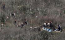 Investigators work at the scene of the helicopter crash which killed NBA star Kobe Bryant in Calabasas