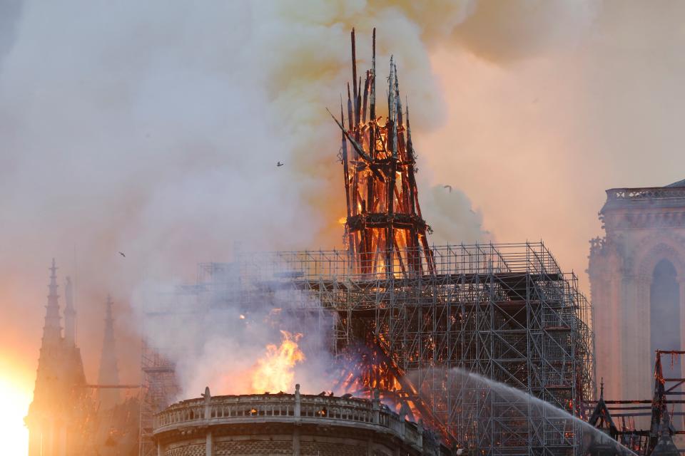 Smoke and flames rise during a fire at the landmark Notre-Dame Cathedral in central Paris on April 15, 2019, potentially involving renovation works being carried out at the site, the fire service said. (Photo: Francois Guillot/AFP/Getty Images)