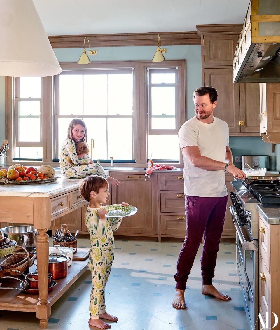 Grace, Harry, and Pete in the kitchen. The hand-painted floor is by Chris Pearson.