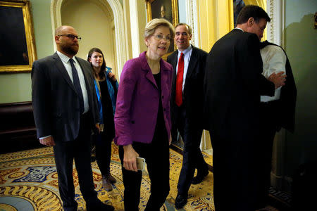 U.S. Senator Elizabeth Warren (D-MA) (3rd L), trailed by U.S. Senator Jeff Merkley (D-OR) (3rd R), arrives for Senate Democratic party leadership elections at the U.S. Capitol in Washington, DC, U.S. November 16, 2016. REUTERS/Jonathan Ernst