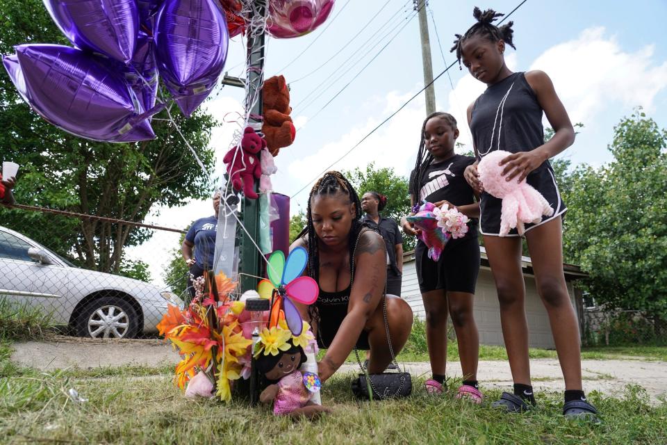Terra Hosea, of Roseville, adds stuffed animals and balloons with her daughters Kenadi Agustas and Kanarie Hosea, right, while stopping at a memorial near an overgrown alley on Erwin Street on Detroit's east side between Olympia Street and Edgewood Street, where the body of Wynter Cole-Smith, 2, was found on Wednesday, July 5, 2023 is seen on Thursday, July 6, 2023. Rashad Trice, 26, is accused of kidnapping Wynter Cole-Smith, 2, on Sunday night after stabbing and assaulting her mother at their home in the 3000 block of BeauJardin Drive in the Towne Square Apartments and Townhomes in Lansing.