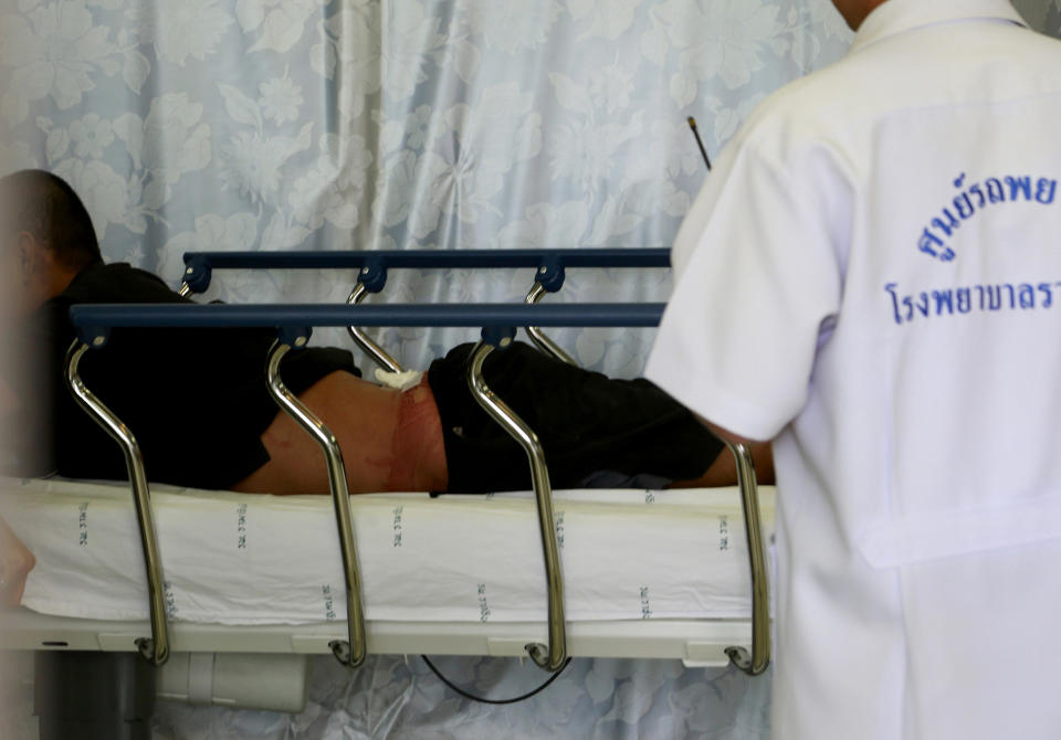 An injured anti-government protester is treated after a bomb attack at an emergency room at Rama hospital in Bangkok, Thailand Sunday, Jan. 19, 2014. Two explosions shook an anti-government demonstration site in Thailand's capital on Sunday, wounding at least 28 people in the latest violence to hit Bangkok as the nation's increasingly volatile political crisis drags on. (AP Photo/Wason Wanichakorn)