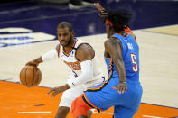 Phoenix Suns guard Chris Paul drives past Oklahoma City Thunder forward Luguentz Dort (5) during the second half of an NBA basketball game, Wednesday, Jan. 27, 2021, in Phoenix. (AP Photo/Matt York)