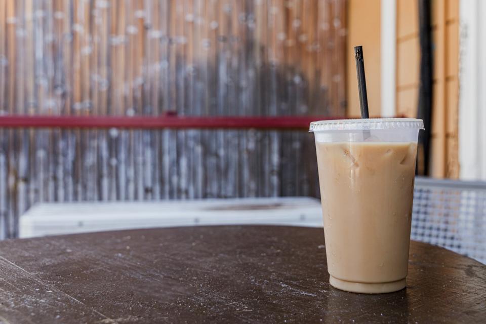 A takeout cup of iced coffee.