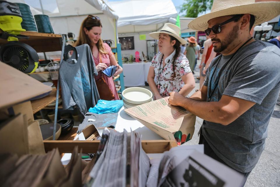 Hector and Melissa Cobos Leon sell to customers at their pottery tent at the 2022 Paseo Art Festival in Oklahoma City.