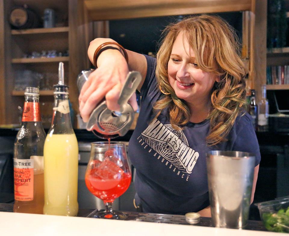 Bartender Nicole Johnson creates a "Raspberry Beret" - raspberry syrup, lemon juice, agave, fresh basil and soda water - at Honey Baby in Plymouth on Thursday, Jan. 10, 2024.