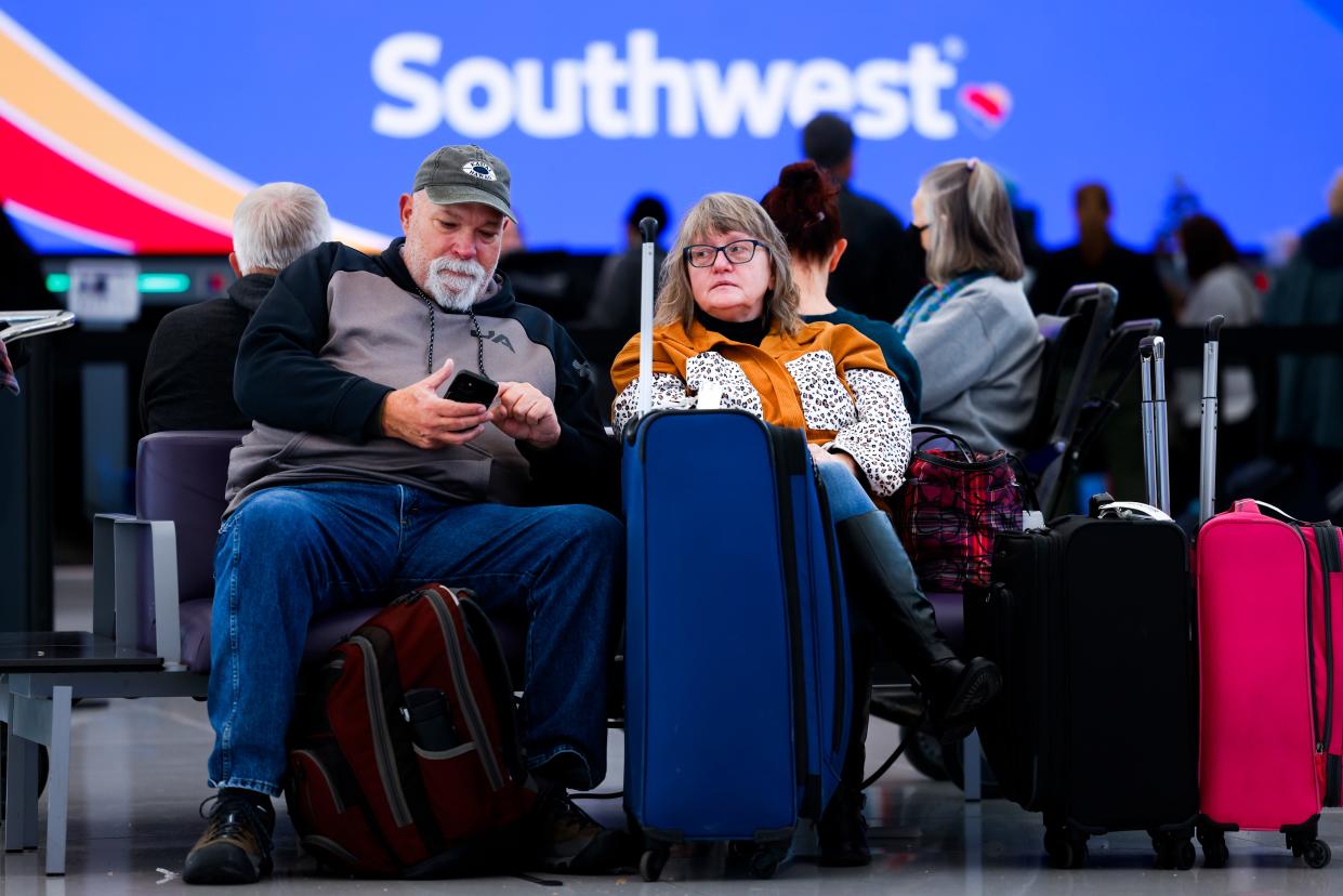 John and Lori Ingoldsby, who drove to Denver after the first leg of their flight on Southwest Airlines was canceled, wait for a flight to finish their trip at Denver International Airport on December 28, 2022 in Denver, Colorado.