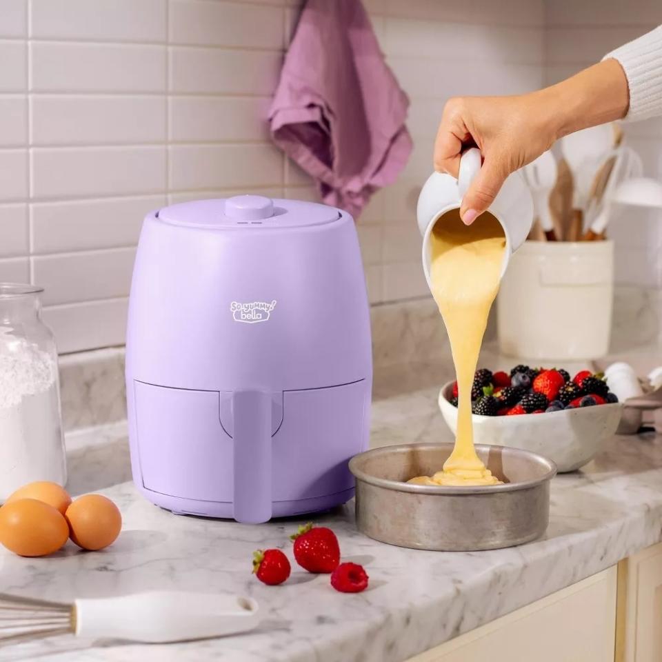 Person pouring batter into air fryer tray