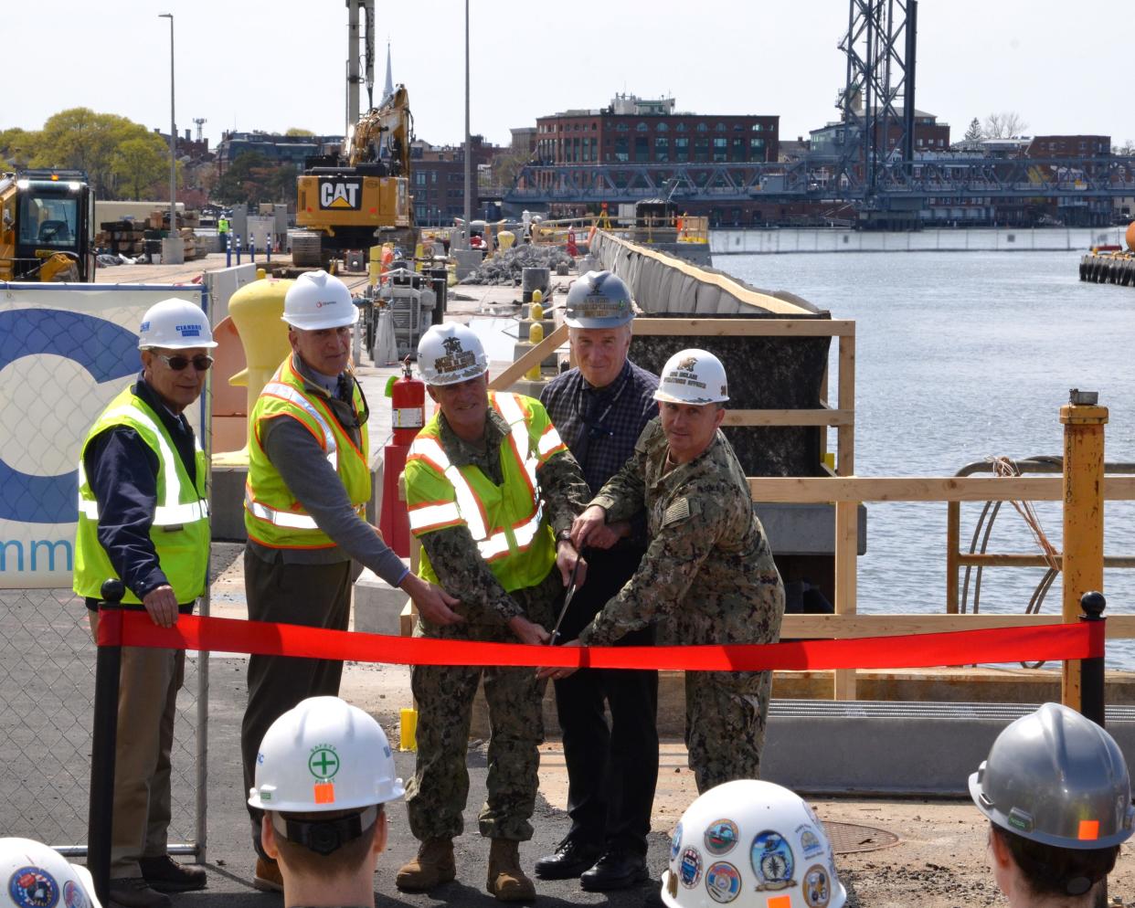 Portsmouth Naval Shipyardheld a ribbon cutting ceremony for the completion of the Dry Dock 1 super food basin Thursday, May 5, 2022.  Left to right are Peter Vigue, chair of Cianbro Company; David Bernier Sr., vice president, Stantec, Inc.; Capt. Frank Carroll, officer in charge of construction; Steve Fahey, shipyard nuclear engineering program department head; and Capt. Brian McLain, acting shipyard commander.