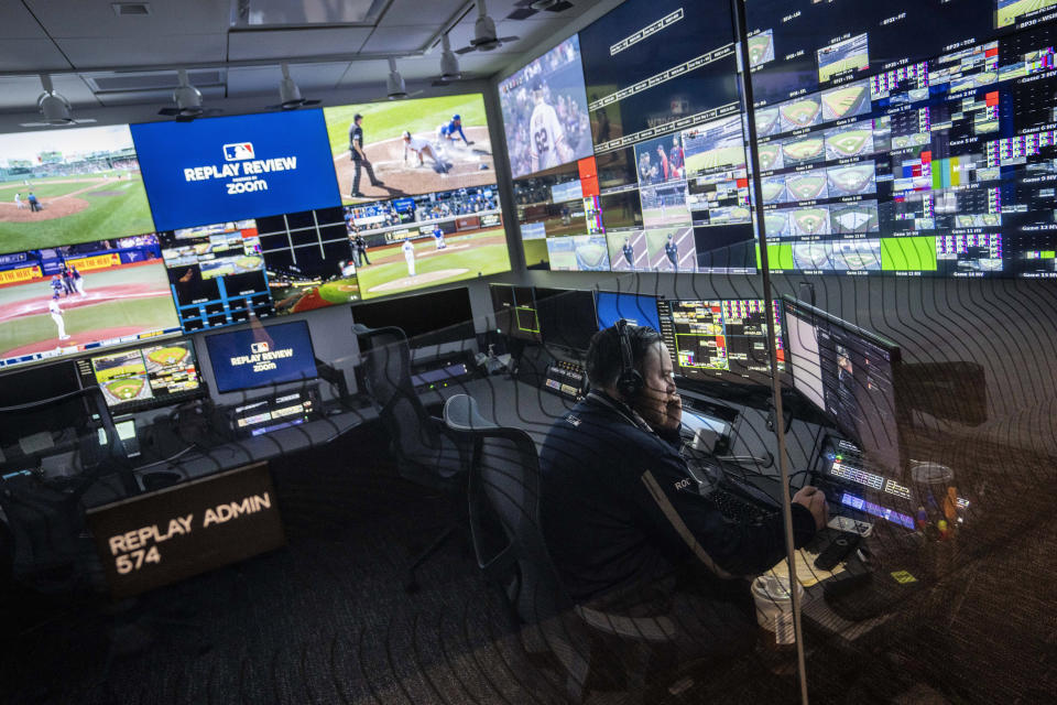 An employee works inside an administrative room at a Replay Review station during a tour at Major League Baseball headquarters in New York, Tuesday, March 28, 2023. (AP Photo/John Minchillo)