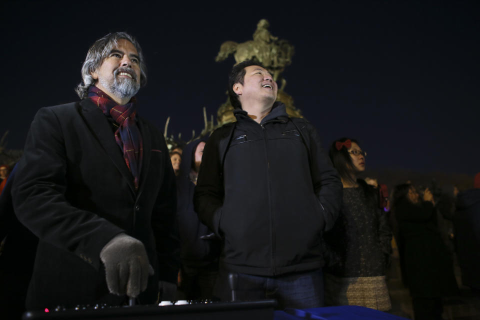 Frank Lee, right, a Drexel University game-design professor, and game designer Henk Rogers play the classic video game Tetris on the 29-story Cira Centre in Philadelphia, Saturday April 5, 2014, using hundreds of LED lights embedded in its glass facade. The spectacle kicks off a citywide series of events called Philly Tech Week and also celebrates the upcoming 30th anniversary of Tetris. (AP Photo/ Joseph Kaczmarek)