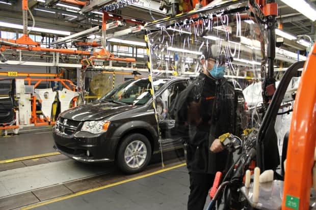 An employee working on the assembly line with added safety precautions at FCA's Windsor Assembly Plant. (Submitted by FCA - image credit)