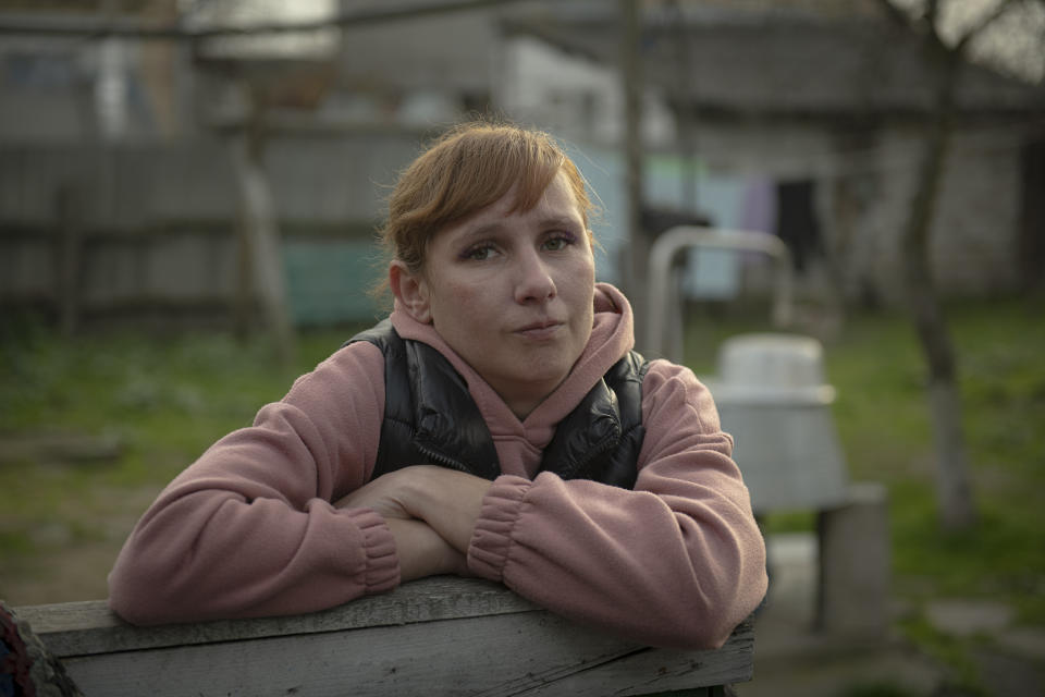 Iryna Stetcenko stands in a yard of her house in the village of Demydiv, about 40 kilometers (24 miles) north of Kyiv, Ukraine, Tuesday, Nov. 2, 2022. Environmental damage caused by Ukraine’s war is mounting in the 8-month-old conflict, and experts warn of long-term health consequences for the population. The World Wildlife Fund in Ukraine says more than 6 million people have limited or no access to clean water. “We don’t have another option. We don’t have money to buy bottles,” Iryna Stetcenko told The Associated Press. (AP Photo/Andrew Kravchenko)