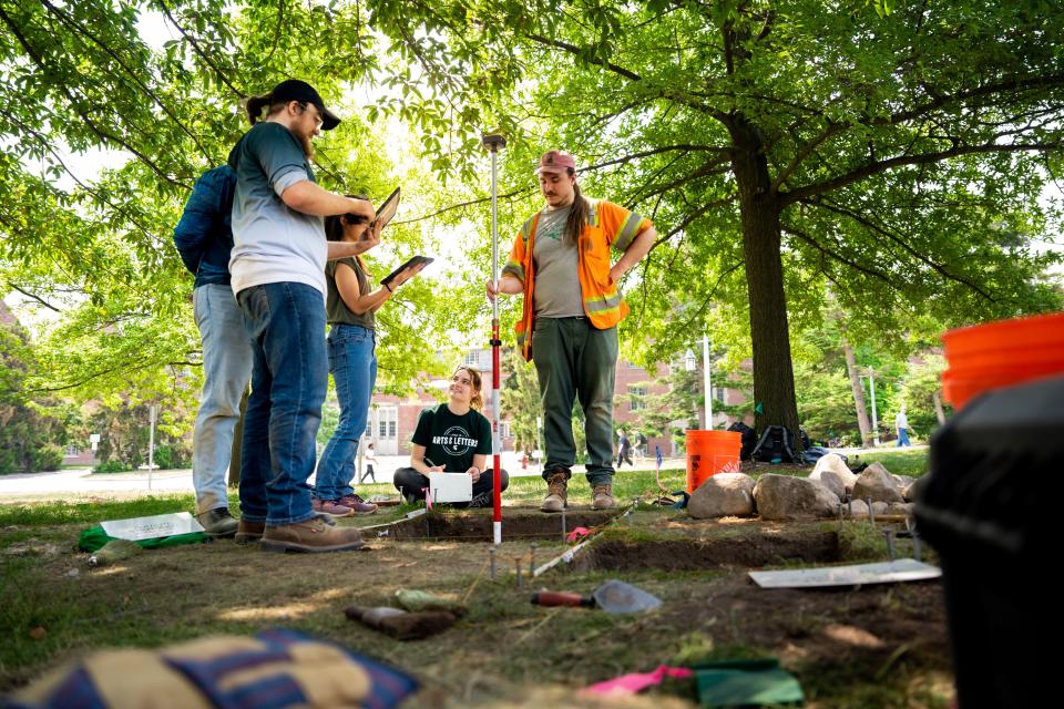 From left, Mac Stevens, Kelly Sullivan, Morgan Manuszak and Campus Archeologist Benjamin Akey from the Campus Archaeology Program near Will House where workers digging a hole for a hammock post found the foundation of the school's first observatory built in 1881.