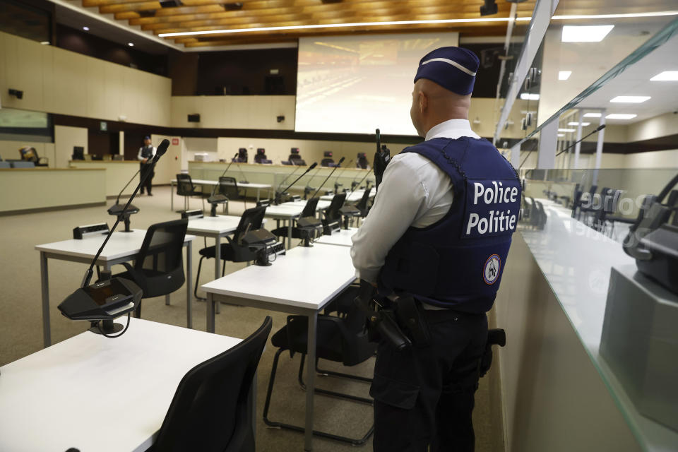 FILE - A police officer stands in the courtroom prior to the selection of the jury for the 2016 Brussels and Maelbeek attacks trial at the Justitia building in Brussels, Nov. 30, 2022. The trial of 10 men accused over the 2016 suicide bombings at Brussels airport and an underground metro station starts in earnest this week. Survivors, and relatives of the 32 people killed in the deadliest peacetime attacks on Belgian soil, are hoping the trial will bring them closure. (Stephanie Lecocq/Pool Photo via AP, file)