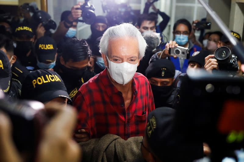 Police officers escort Guatemalan journalist Jose Ruben Zamora after being detained by Guatemalan authorities, in Guatemala City