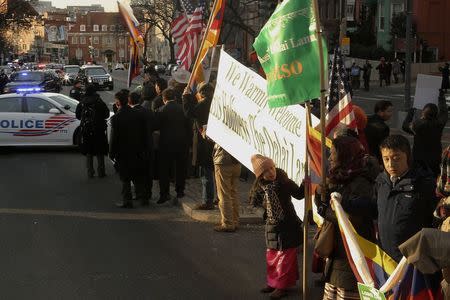 U.S. President Barack Obama's limousine and motorcade (top L) arrive past supporters of the Dalai Lama as they rally outside the site of the National Prayer Breakfast, which both men are attending, at the Washington Hilton in Washington, February 5, 2015. REUTERS/Jonathan Ernst