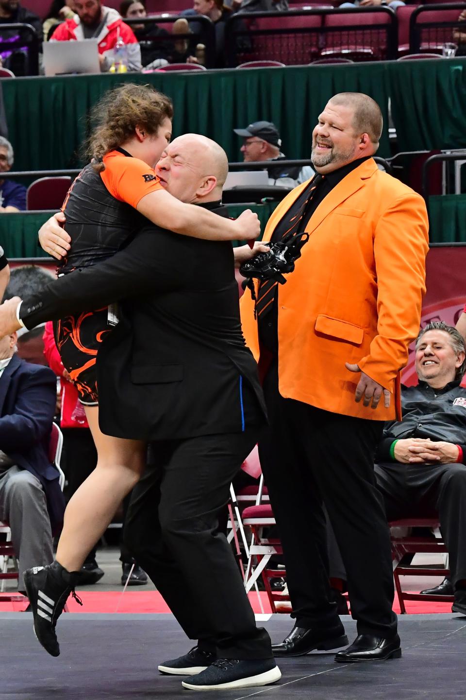 Elizabeth Madison receives an embrace of joy from the Loveland coaches after winning the 170-pound championship at the OHSAA inaugural girls wrestling state tournament, March 10-12, 2023.