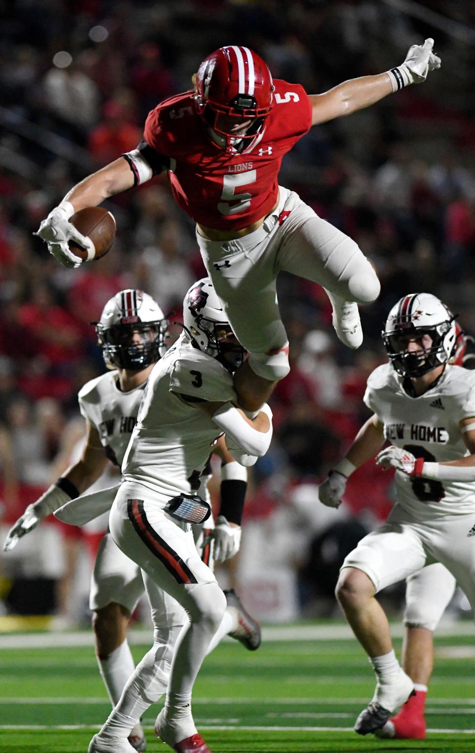 Albany's Adam Hill, top, hurdles over New Home's Brazos Beck for a big gainer Thursday's night.