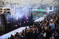 Israeli musician Ivri Lider performs in front of audience, where all guests were required to show "green passport" proof of receiving a COVID-19 vaccination or full recovery from the virus at a soccer stadium in Tel Aviv, Friday, March. 5, 2021. (AP Photo/Oded Balilty)