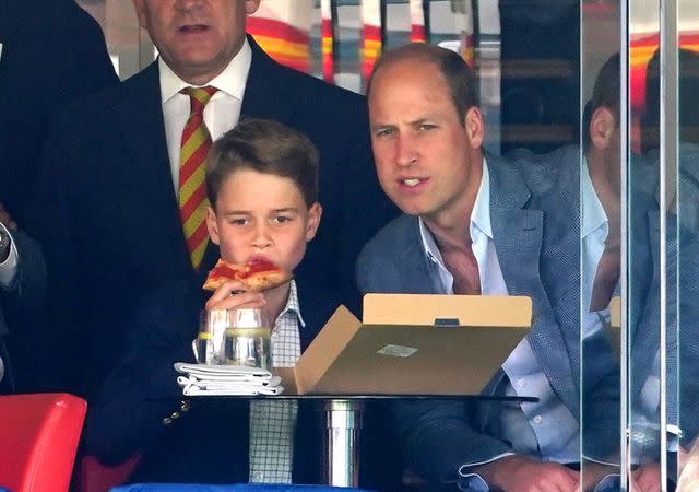 <p>Mike Egerton/PA Images via Getty</p> Prince George and Prince William watch cricket in London on July 1.