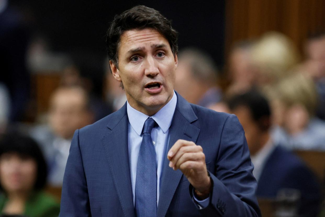 Justin Trudeau looks serious and intense and gestures with his hand.