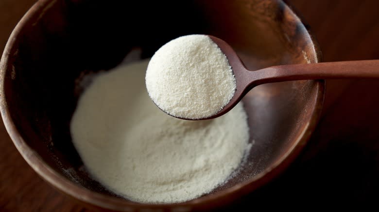 Milk powder in a bowl and spoon