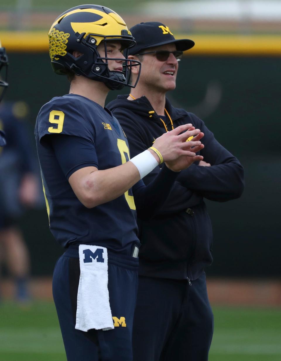 Jim Harbaugh talks with Michigan quarterback J.J. McCarthy during drills at the Los Angeles Angels training facility in preparation before the Fiesta Bowl against TCU on Thursday, Dec. 29, 2022, in Tempe, Arizona.