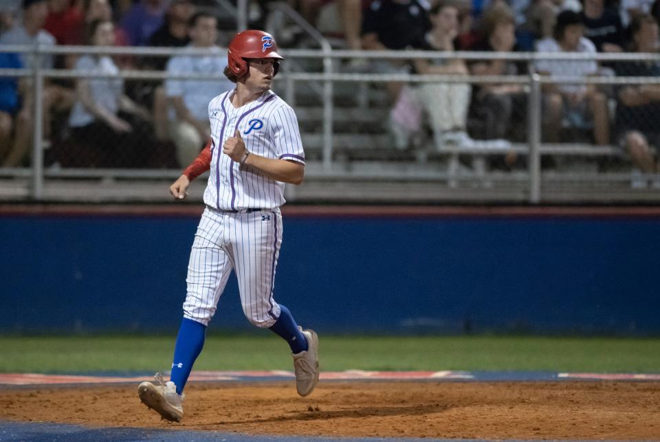 Andrew Krevatas (3) scores to give the Patriots a 4-2 lead as Austin Starkie (1) is tagged out heading into second base on a fielders choice hit by Brent Cadenhead (2) during the Tate vs Pace 6A District 1 championship baseball game at Pace High School on Thursday, May 5, 2022.