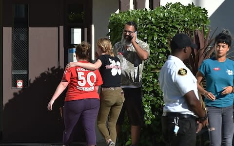 Trader Joe's staff comfort each other - Credit: Robyn Beck/AFP