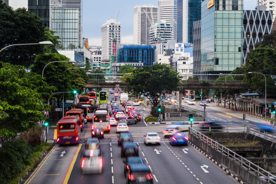 Vehicles moving on a road in downtown Singapore, illustrating a story on Certificates of Entitlement (COE).
