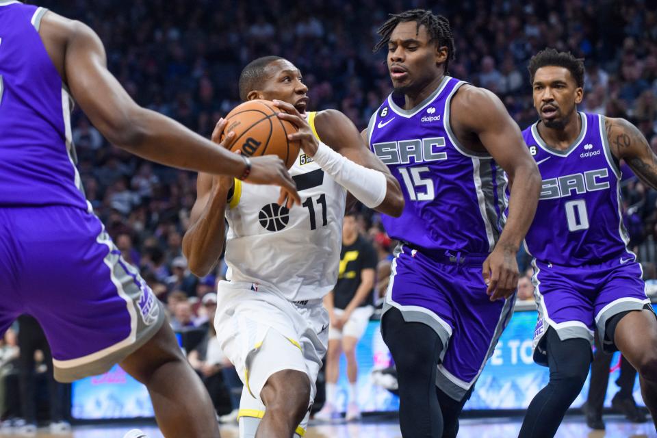 Utah guard Kris Dunn (11) drives to the basket past Sacramento guard Davion Mitchell (15) and guard Malik Monk (0) during the first quarter of a game last March. Dunn signed a two-year, $3,322,303 contract with the Jazz,