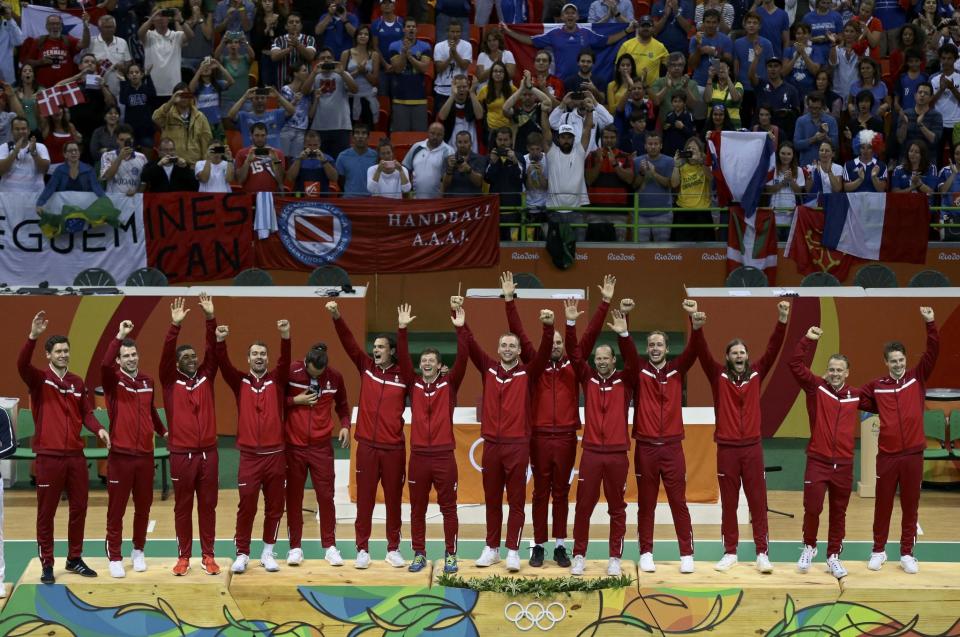 <p>Denmark’s players celebrate on the winners podium. (Reuters) </p>