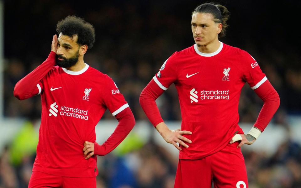 Liverpool's Mohamed Salah, left, and Liverpool's Darwin Nunez react during the English Premier League soccer match between Everton and Liverpool