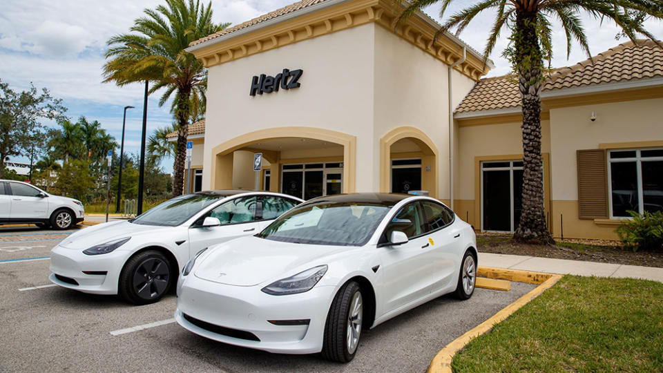 Tesla EVs in front of a Hertz rental center - Credit: Hertz