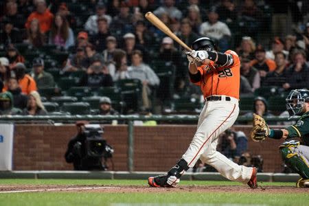 Jul 13, 2018; San Francisco, CA, USA; San Francisco Giants catcher Buster Posey (28) hits an RBI double during the eighth inning of the game against the Oakland Athletics at AT&T Park. Mandatory Credit: Ed Szczepanski-USA TODAY Sports