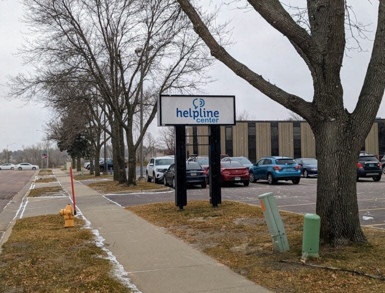 A sign outside the Sioux Falls location of the Helpline Center, one of three call centers across the state that connects callers to a range of services.