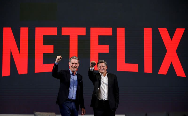 FILE PHOTO: Reed Hastings, co-founder and CEO of Netflix, and Ted Sarandos, Netflix chief content officer, pose for photographs during a news conference in Seoul