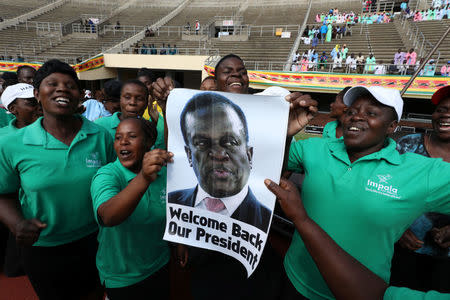 People wait for the inauguration ceremony to swear in Zimbabwe's former vice president Emmerson Mnangagwa as president in Harare, Zimbabwe, November 24, 2017. REUTERS/Mike Hutchings