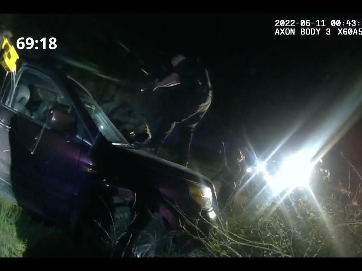 Screenshot from bodycam video released by the lawyers of Christian Glass' family shows officers surrounding Glass' car, breaking his window and tasing him before he was shot and killed on June 11.