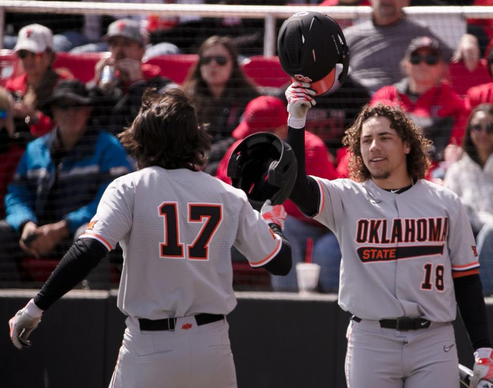 OSU's Tyler Wulfert (17) and Beau Sylvester (18) celebrate Wulfert's home run against Texas Tech on Saturday at Rip Griffin Park in Lubbock.