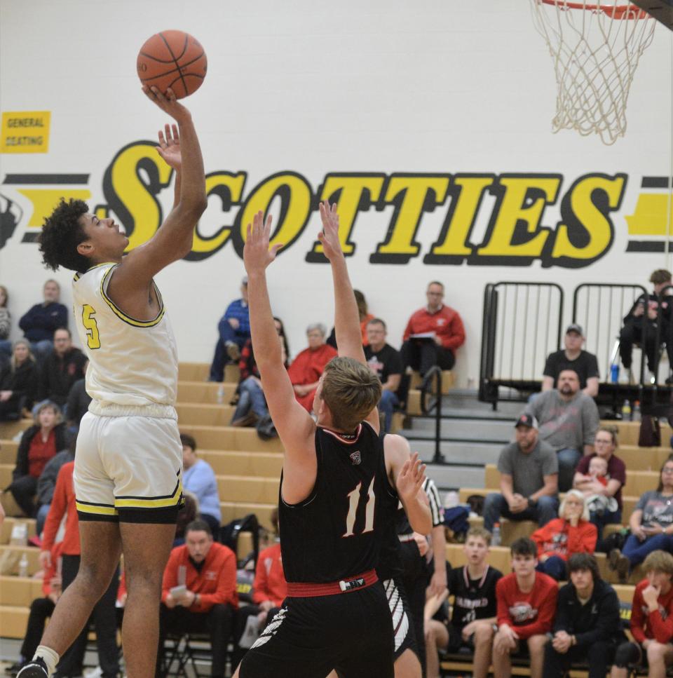 Tri-Valley's Terrell Darden puts a shot up over Fairfield Union's Caleb Redding in Thursday's game. The Scotties won 54-49.