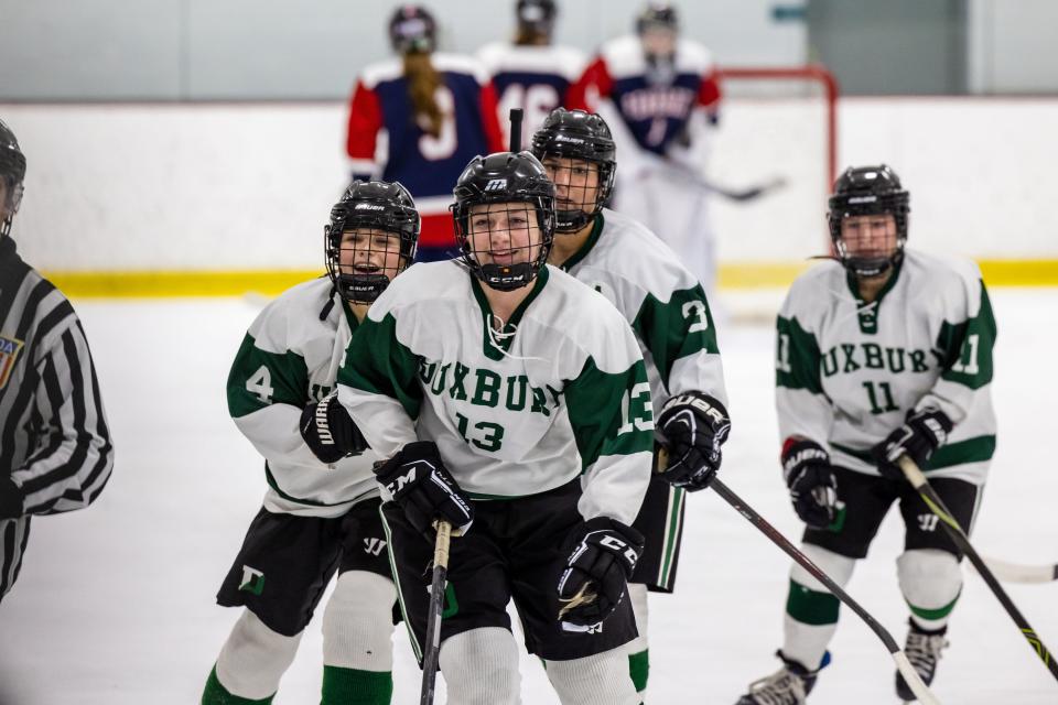 Varsity Duxbury girls hockey players celebrate during a game against Pembroke on Wednesday, Jan. 25, 2023.