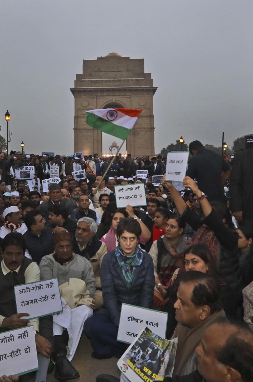 Congress party leader Priyanka Gandhi, center, joins other leaders during a sit in protest against a new citizenship law near the India Gate monument in New Delhi, India, Monday, Dec.16, 2019. The new law gives citizenship to non-Muslims who entered India illegally to flee religious persecution in several neighboring countries. (AP Photo/Manish Swarup)