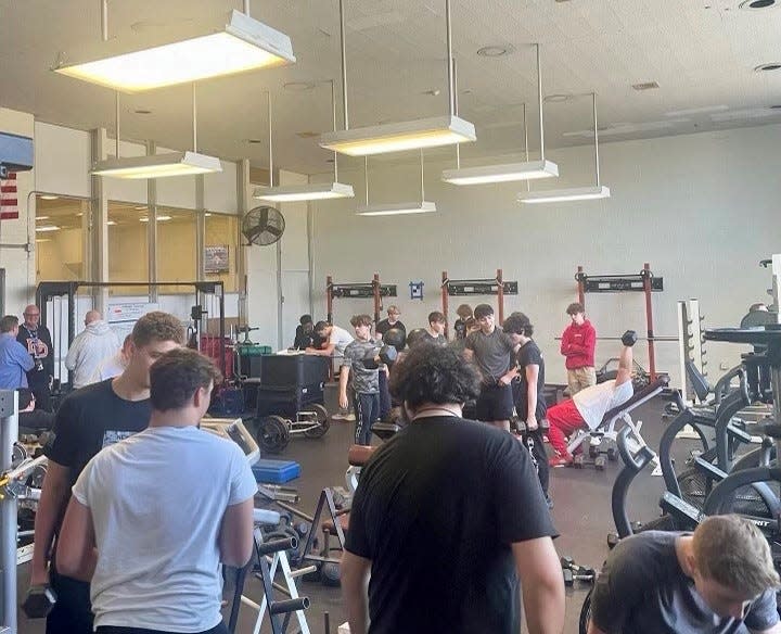 The Dover football team works out in its weight room during an offseason training sessions in March 2023. The team is prepares for a return to 11-player football in the fall.