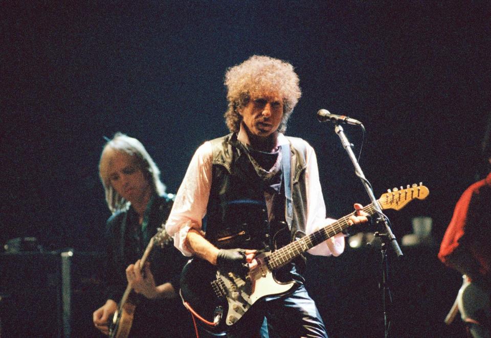 Bob Dylan was good friends with Tom Petty (shown here together in concert in 1986), who he teamed up with in the Traveling Wilburys supergroup in the late 1980s.